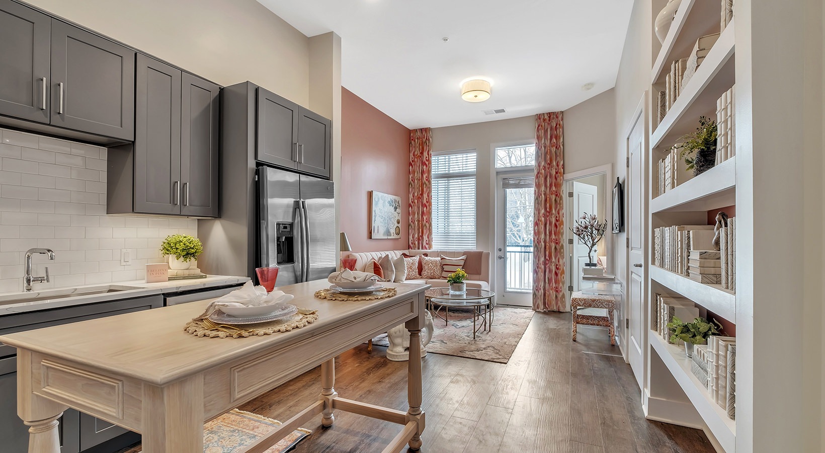 Open Concept Kitchen and Living Room Model kitchen at our senior living apartments in Plainsboro, NJ, featuring a kitchen island and stainless steel appliances.