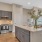 Model kitchen at our active adult apartments, featuring stainless steel appliances and a kitchen island with marble counters.