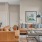 Model living room at our senior living apartments in Plainsboro, NJ, featuring wood grain floor paneling and couches.