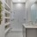 Model bathroom at our senior living apartments in Princeton, NJ, featuring white counters and a shower with a glass door.