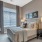 Model bedroom at our senior living apartments in Plainsboro, NJ, featuring windows with blinds and a large bed.