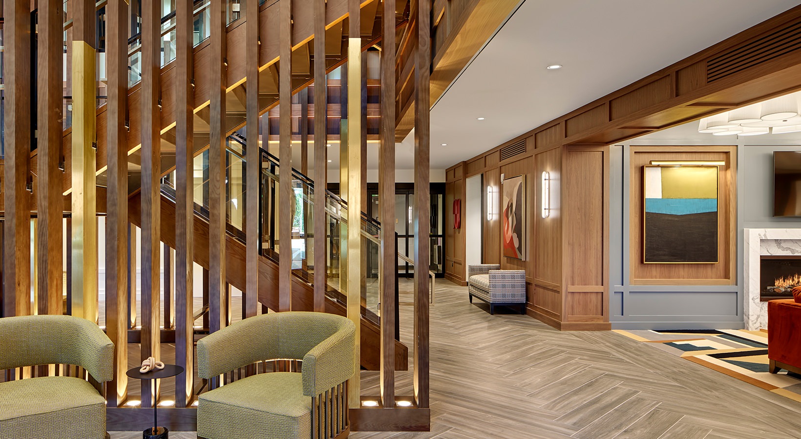 Foyer/Entrance Lounge and lobby at our apartments in Princeton, featuring wood grain floor paneling and couches with tables.
