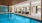 The indoor pool area at our 55+ apartments in Plainsboro, featuring cushioned chairs, towels, and a tiled wall.