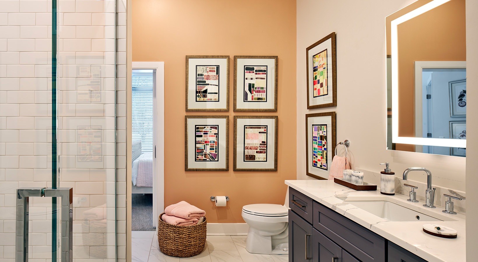 Designer Bathroom Model bathroom at our senior living apartments in Princeton, NJ, featuring marble counters and a shower with a glass door.