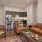 Model living room at our senior living apartments in Plainsboro, NJ, featuring wood grain floor paneling and couches.